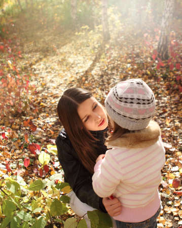 Two talking sisters in the autumn forestの写真素材