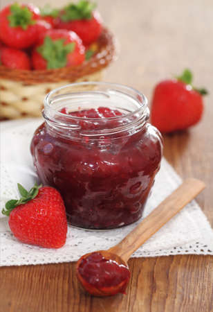 Strawberry jam and fresh strawberries on the wooden tableの写真素材