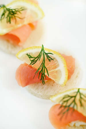 Extreme close-up of smoked salmon served with lemon, cheese and dillの写真素材