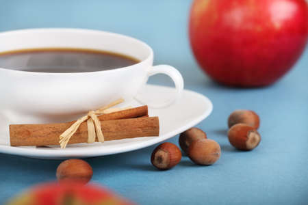 Coffee with cinnamon and apples on the blue backgroundの写真素材