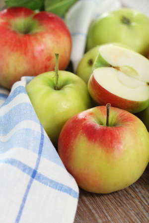 Red and green apples with leaves on the tableの写真素材