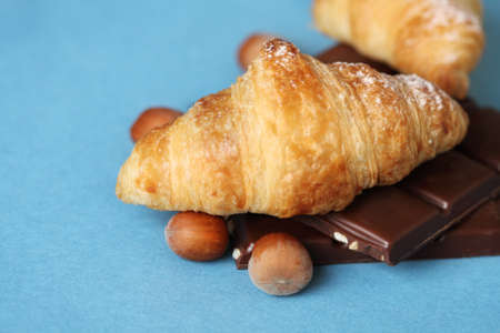 Croissants with chocolate and nuts on the blue backgroundの写真素材