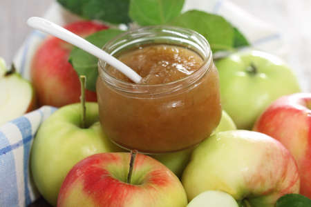 Apple jam with red and green apples on the tableの写真素材