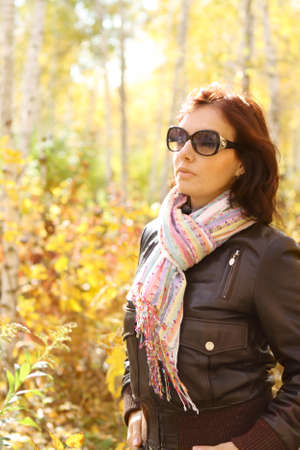 Young atractive woman in the sunny autumn forestの写真素材