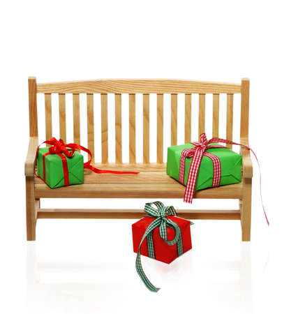 Christmas wooden bench with presents over whiteの写真素材