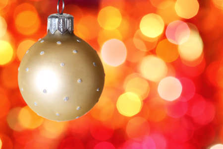 Christmas tree decoration against red blurred backgroundの写真素材