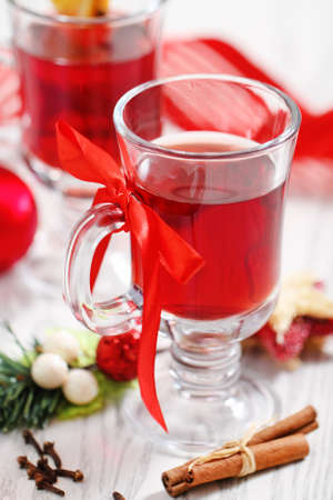 Orange and cranberry punch with spices and Christmas decorationの写真素材