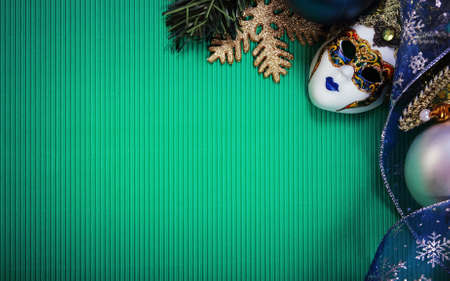 Christmas card with carnival mask, Christmas ribbon, Christmas tree branches and Christmas balls. Paper with decorations and copy spaceの写真素材