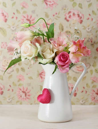 Bouquet of white and pink roses in the pot decorated by heartの写真素材