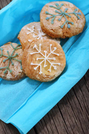Cookies decorated with snowflakes on the blue paperの写真素材