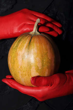 Woman holding halloween dramatic magic pumpkinの写真素材