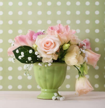Bouquet of white and pink roses in the green vaseの写真素材