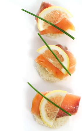 Extreme close-up of smoked salmon served with lemon, cheese and onionの写真素材