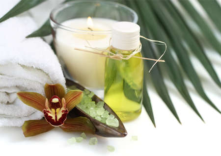 Spa setting with orchid, burning candles and saltの写真素材