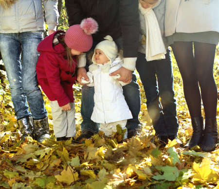 Young happy family with children in autumn forestの写真素材