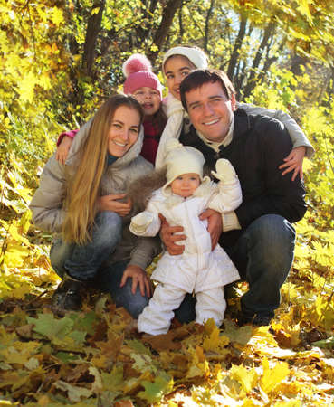 Young happy family with three daughters in autumn forestの写真素材