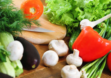 Fresh vegetables on the wooden background at the kitchenの写真素材