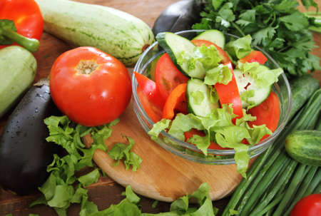 Fresh vegetables on the wooden background at the kitchenの写真素材