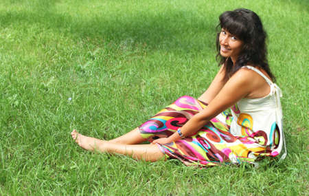 Young smiling brunette woman in summer parkの写真素材