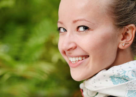Young smiling blonde woman in the parkの写真素材