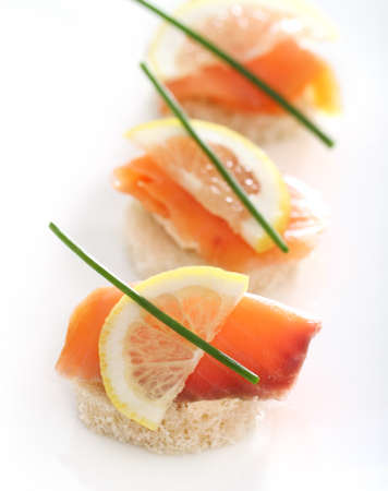 Extreme close-up of smoked salmon served with lemon, cheese and onionの写真素材