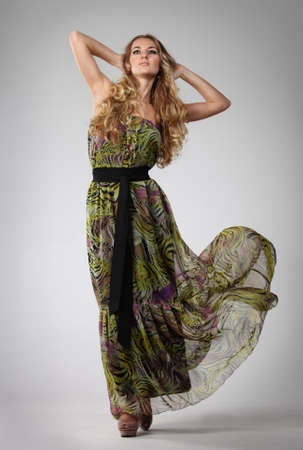 Portrait of the beautiful blond girl in long green dressの写真素材