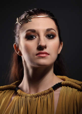 Portrait of the beauty young brunette woman in antic style in low keyの写真素材