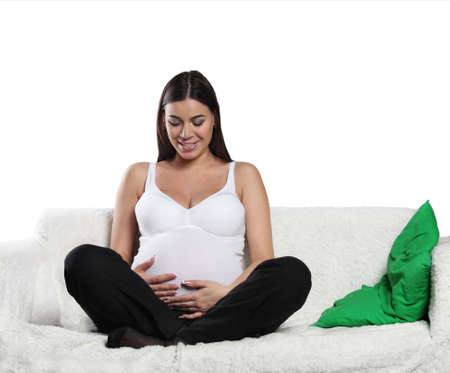 Happy pregnant woman touching her bellyの写真素材
