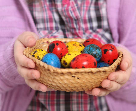 Cute little girl holding basket with easter eggs. Close upの写真素材
