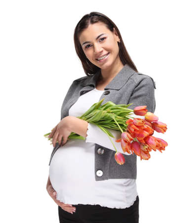 Happy pregnant woman with bouquet of orange tulipsの写真素材