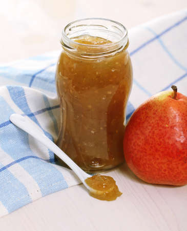 Pear jam and fresh pear on the wooden tableの写真素材