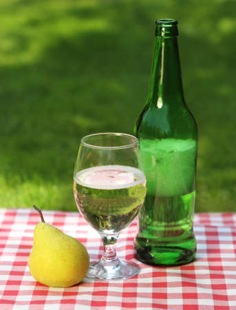Pear cider and one pear on the summer picnicの写真素材