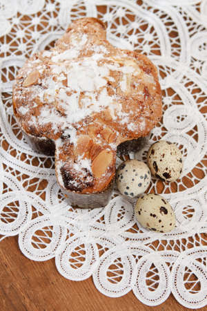 Spotted eggs and easter pie on wooden background with space for textの写真素材