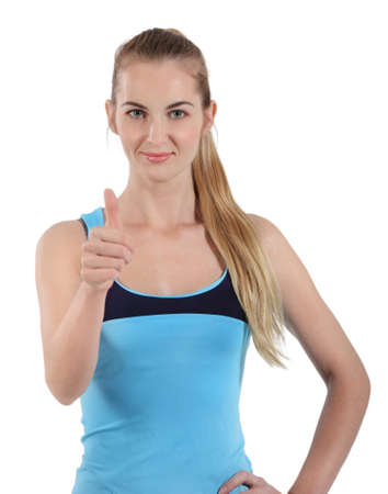 Young attractive woman on white background with thumb upの写真素材