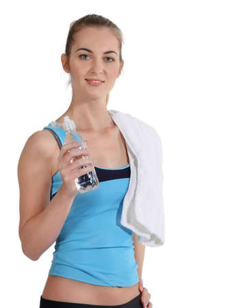 Attractive sporty woman with water and towel on white background の写真素材