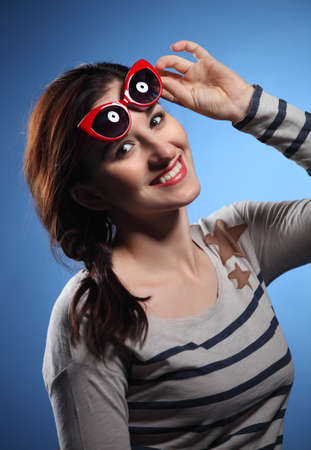 
Portrait of the lovely woman in retro style over blue backgroundの写真素材