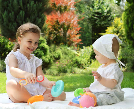 
Two playing little sisters in the summer gardenの写真素材