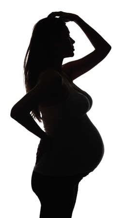Silhouette of the pregnant woman isolated on whiteの写真素材