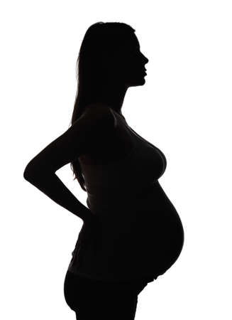 Silhouette of the pregnant woman isolated on whiteの写真素材