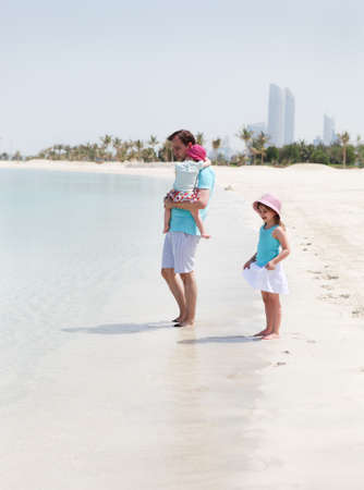 Father and his two little daughters enjoying vacationの写真素材