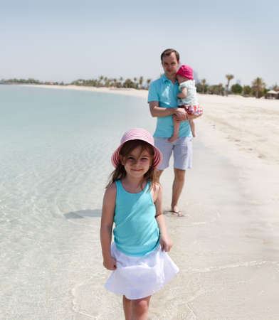 Father and his two little daughters enjoying vacationの写真素材