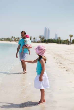 Father and his two little daughters enjoying vacationの写真素材