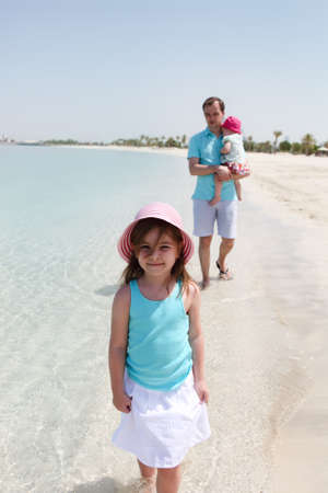 Father and his two little daughters enjoying vacationの写真素材