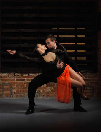 Tango dancers in action against brick wallの写真素材