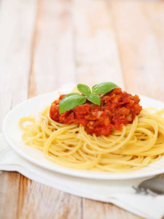 Spaghetti Bolognese on white plate on wooden tableの写真素材
