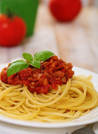 Spaghetti Bolognese on white plate on wooden tableの写真素材