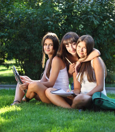 Happy young girls having fun using a tablet computerの写真素材