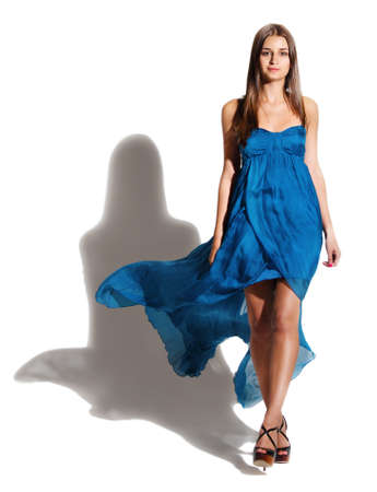 Portrait of the beautiful brunette girl in long blue dressの写真素材