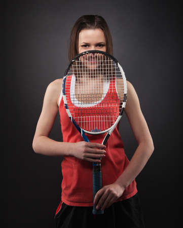 Portrait of sporty teen girl tennis player with racketの写真素材