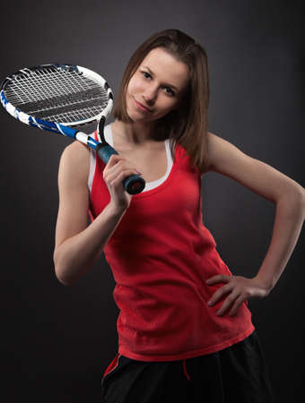 Portrait of sporty teen girl tennis player with racketの写真素材